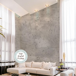 May include: A white sectional sofa with pillows sits in a living room with a gray concrete wall, a wooden coffee table, and a small side table with a plant on it. The text "PSD Digital Mockup" is on a white circle with a black border.