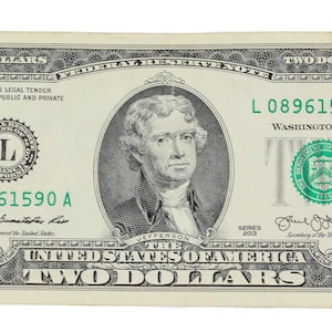 May include: A United States two-dollar bill. The bill features a portrait of Thomas Jefferson and the text "The United States of America Two Dollars". The bill is primarily green and black with intricate designs and serial numbers.