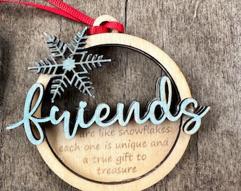 May include: Wooden Christmas bauble featuring a snowflake design and the text "Friends are like snowflakes: each one is unique and a true gift to treasure."