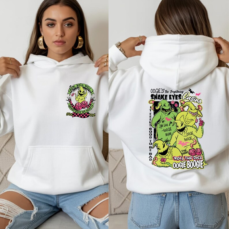 May include: White hoodie featuring a graphic of Oogie Boogie from The Nightmare Before Christmas. The front has a small design, while the back displays a larger, colorful illustration with text including "Snake Eyes Casino" and "Roll the Dice".