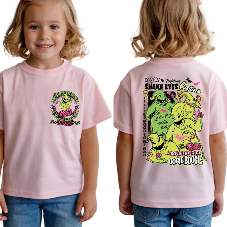 May include: A light pink t-shirt featuring a cartoon graphic of a character with the text "WELL WELL WELL WHAT HAVE WE HERE" on the front. The back of the shirt has a graphic with the text "OOGIE'S Too Frightening SNAKE EYES Casino".