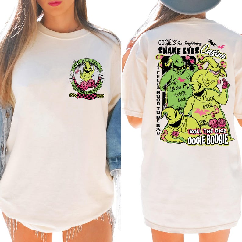 May include: Cream-colored t-shirt featuring a graphic of Oogie Boogie from The Nightmare Before Christmas. The front has a circular design with text. The back displays Oogie Boogie characters with text that reads "Oogie's Too Frightening Snake Eyes Casino."
