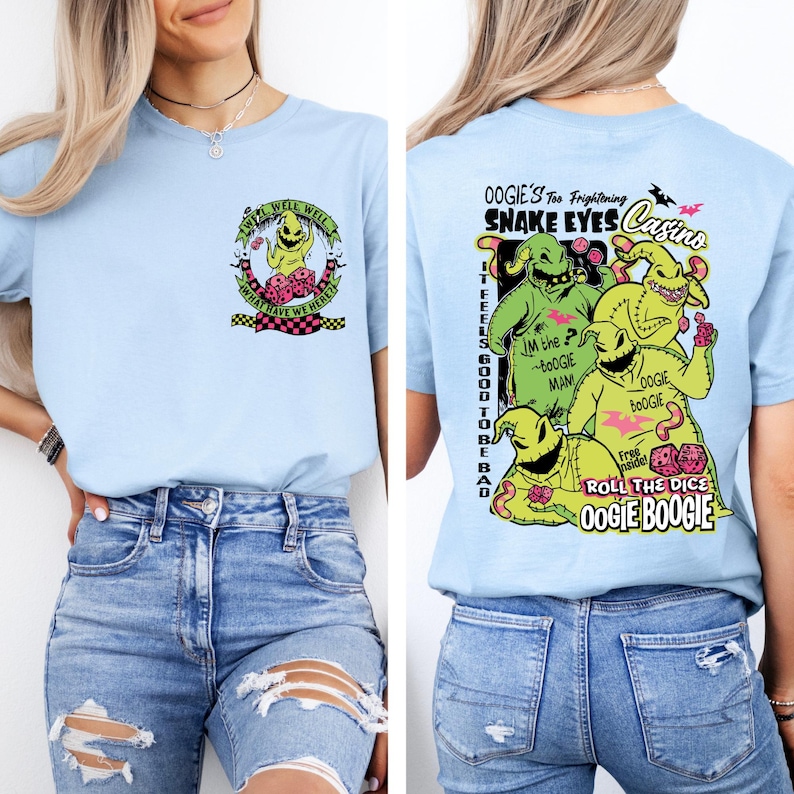 May include: Light blue t-shirt featuring Oogie Boogie from The Nightmare Before Christmas. The front graphic includes text "Well, Well, Well, What Have We Here?". The back graphic features Oogie Boogie and text "Oogie's Too Frightening Snake Eyes Casino".