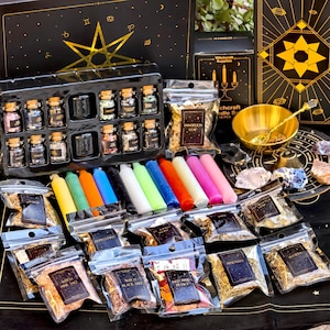 May include: A witchcraft supply kit featuring a black plastic tray with ten small glass jars filled with various crystals, a set of twelve colourful taper candles, multiple clear plastic pouches containing dried herbs, a gold bowl, and a black mat.