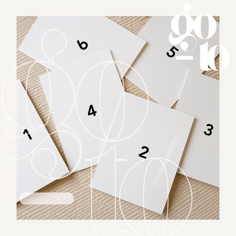 May include: An overhead shot of six white rectangular cards arranged on a beige surface. Each card is numbered from 1 to 6 in black. The words "go to" are overlaid in a light color.