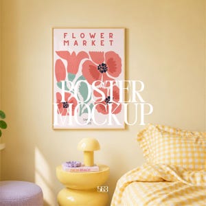 May include: A framed poster with the words "FLOWER MARKET" and a floral design in pink, red, and blue. The poster is hanging on a yellow wall. A yellow side table with a lamp and books is in front of the wall.