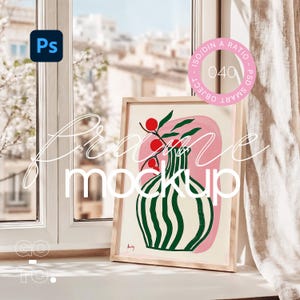 May include: A framed illustration of a green and white striped vase with red berries and green leaves on a pink background. The frame is light brown wood.