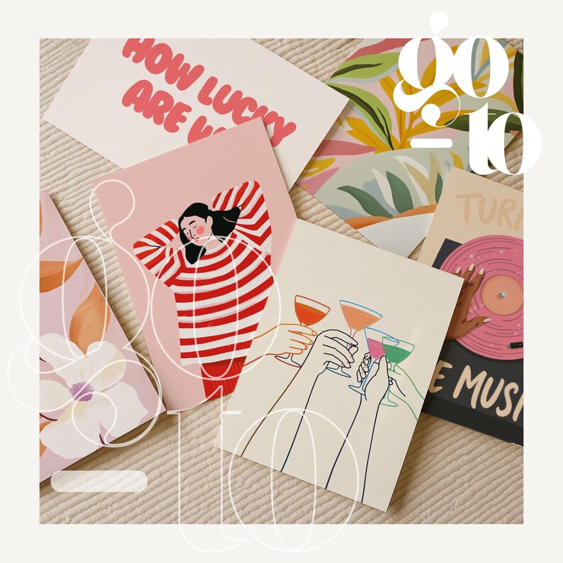 May include: A collection of greeting cards with various illustrations and text. One card reads "How Lucky Are V" in pink letters. Other cards feature images of people, cocktails, and a record player. The cards are arranged on a textured surface.