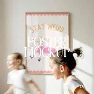 May include: A framed poster with the words "STAY WEIRD" in gold lettering. The poster features a cartoon illustration of a dog wearing a pink jacket and roller skates. The frame has a scalloped pink border. Two young girls are in the foreground.