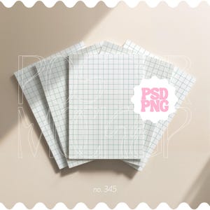 May include: A stack of white notebooks with a grid pattern, arranged on a light beige surface. The notebooks have a light green grid and the text "PSD PNG" in a pink starburst. The number "no. 345" is also visible.