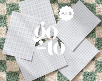 May include: A collection of graph paper sheets arranged on a checkered green and white surface. The text "go to" is overlaid in a large, white font, with "NO. 411" in a smaller circle.