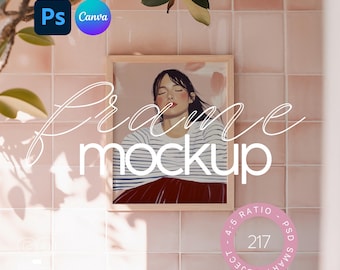 May include: A wooden frame mockup with a picture of a woman with closed eyes in a striped shirt and a red skirt. The frame is hanging on a pink tiled wall.