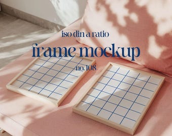 May include: Two wooden picture frames with a grid pattern on a pink couch. The frames are empty and ready for your photos. The text "iso din a ratio frame mockup no. 108" is visible in the image.