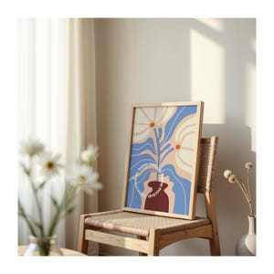 May include: A framed print with a blue, white, and orange abstract floral design. The print is in a wooden frame and is hanging on a wall. The text "frame mockup" is written around the frame.