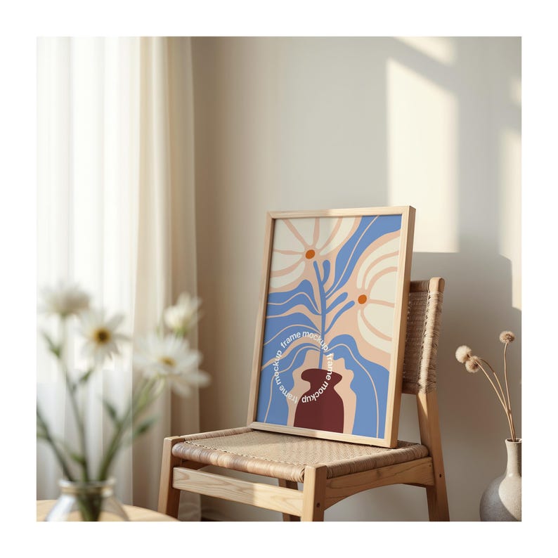 May include: A framed print with a blue, white, and orange abstract floral design. The print is in a wooden frame and is hanging on a wall. The text "frame mockup" is written around the frame.