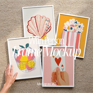 May include: Four framed art prints with white frames. The prints depict a seashell, a basket of fruit, a popcorn container, and a hand holding an Ace of Hearts card. The text "With Person Frame Mockup" and "Mockup no. 465" are visible.