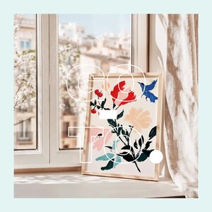 May include: A framed print of a floral design with colourful flowers and birds. The print is in a wooden frame and is sitting on a windowsill.