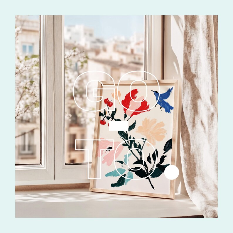 May include: A framed print of a floral design with colourful flowers and birds. The print is in a wooden frame and is sitting on a windowsill.