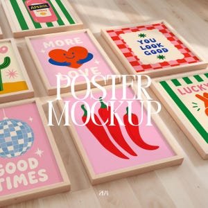 May include: A collection of framed rectangular posters featuring various graphic designs including a red heart, red chili peppers, a blue disco ball, a checkered pattern with the text YOU LOOK GOOD, and an Aperol Spritz illustration in light wood frames.