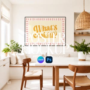 May include: A poster mockup featuring a framed print with the text "What's Cookin?" in a retro font. The poster is displayed in a bright, modern dining room setting with a white table, wooden chairs, and a woven pendant light.