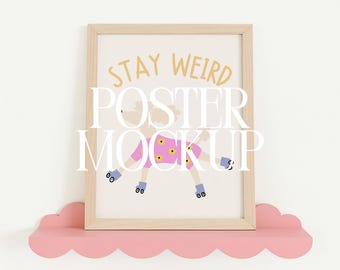May include: A light wood frame containing a print with the text STAY WEIRD in yellow letters above a graphic of a dog wearing a pink shirt with yellow flowers and blue roller skates, resting on a pink scalloped shelf with 4:5 RATIO text.