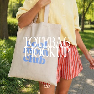 May include: A beige tote bag with the words "TOTEBAG MOCKUP Club" in blue and white. The bag is held by a person wearing a yellow sweater and red and white striped shorts. The number "556" is at the bottom of the bag.