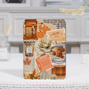 May include: A decorative phone case featuring a collage of fall-themed elements. The design includes pumpkins, a bookstore illustration, coffee cups, and the text "Forever Bookish." The color palette is warm, with shades of orange, brown, and beige.