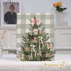 May include: A Christmas-themed notebook with a green and white plaid background. The cover features a decorated Christmas tree with ornaments, bows, gingerbread stars, and a snow globe. The notebook is decorated with the words "Wupong Art".