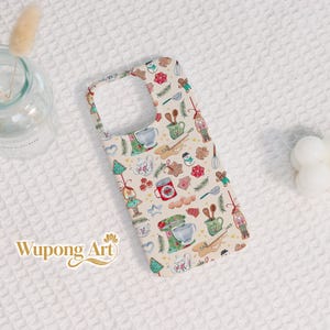 May include: A phone case with a festive Christmas baking theme. The case features a cream background with repeating illustrations of gingerbread men, Christmas trees, kitchen mixers, and teacups. The text "Wupong Art" is visible on the case.