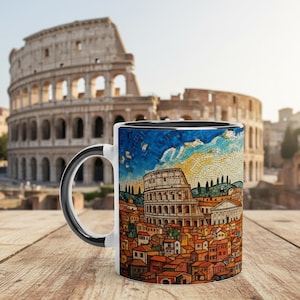 May include: A ceramic mug featuring a colorful mosaic-style illustration of the Roman Colosseum and surrounding city buildings with orange rooftops under a blue and yellow sky. The mug has a solid black handle and a white interior rim.