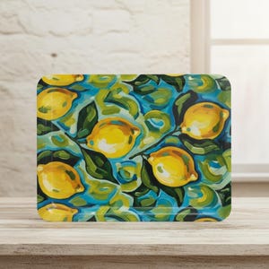 May include: Rectangular serving tray with a vibrant lemon design. The tray features bright yellow lemons with green leaves against a blue and green background. The artwork has a painterly style, adding a touch of artistic flair to the kitchen.