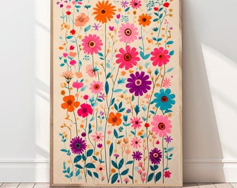 May include: A framed floral print featuring a vibrant array of colorful flowers in shades of orange, pink, purple, and blue against a cream background. The artwork is displayed on a wooden floor, leaning against a white wall.