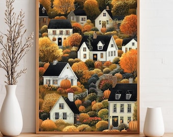 May include: A framed autumn-themed print featuring a village scene. White houses with black roofs are nestled among trees with orange and yellow foliage. Pumpkins are placed throughout the scene, creating a warm, inviting fall atmosphere.