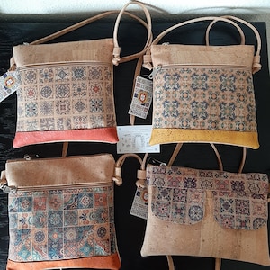 May include: Four cork crossbody bags with patterned tile designs. The bags have a light brown color with colorful tile patterns and a zipper closure. Each bag has a different colored bottom trim: coral, yellow, and orange. The bags have adjustable straps.
