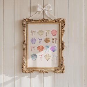 May include: A gold framed print with a white background featuring a watercolour illustration of 16 seashells with colourful bows. The seashells are arranged in a grid pattern.
