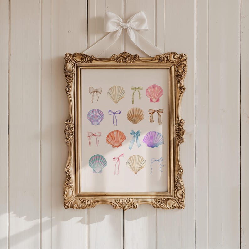 May include: A gold framed print with a white background featuring a watercolour illustration of 16 seashells with colourful bows. The seashells are arranged in a grid pattern.