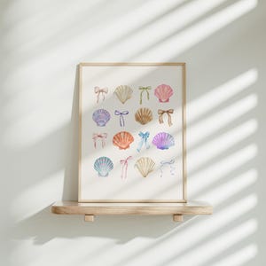May include: A framed print with a white background featuring a collection of watercolour illustrations of seashells with colourful bows. The seashells are arranged in a grid pattern.