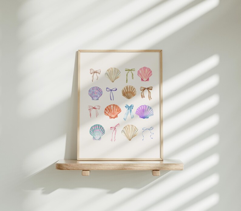May include: A framed print with a white background featuring a collection of watercolour illustrations of seashells with colourful bows. The seashells are arranged in a grid pattern.