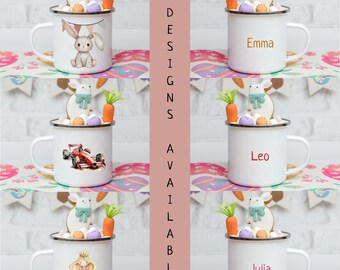 May include: Twelve different designs of personalized enamel mugs with various images and names. The mugs are white with a black rim and handle. The images include a bunny, a race car, and a princess. The names on the mugs are Emma, Leo, and Julia.