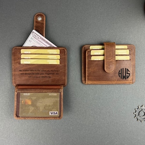 May include: A brown leather wallet with a flap closure and multiple card slots. The wallet has a personalized inscription that reads "No matter where life takes us, my heart will always be with you. Together, we can conquer anything." The wallet also has a monogrammed initials "HWS" on the front.