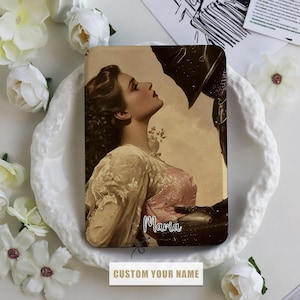 May include: A rectangular case with a vintage image of a woman in a pink dress gazing up at a knight. The name "Maria" is written in cursive. The text "CUSTOM YOUR NAME" is at the bottom.