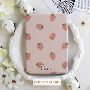May include: A pink e-reader cover with a strawberry pattern and the name "Maria" printed on it. The text "Custom Your Name" is printed below the cover.