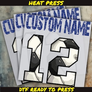 May include: Several gray DTF (Direct to Film) transfer sheets with a soccer ball design and the number 12. The text "CUSTOM NAME" is printed in blue at the top. The text "HEAT PRESS" and "DTF READY TO PRESS" are printed in yellow and black.