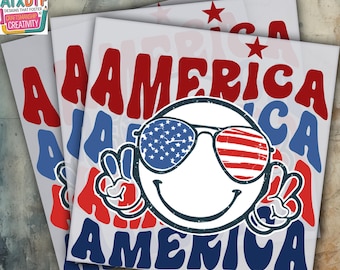May include: A stack of DTF (Direct to Film) heat transfer sheets featuring a patriotic design. The design includes the word "AMERICA" in red and blue, a smiley face wearing sunglasses with the American flag design, and peace signs.