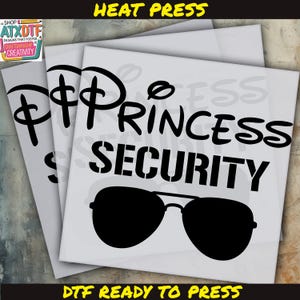 May include: A white heat transfer design with black text that reads "Princess Security" with a pair of sunglasses underneath. The design is ready to be pressed onto a t-shirt or other fabric.