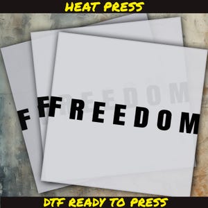 May include: Stacked white DTF (Direct to Film) transfer sheets with the word "FREEDOM" in bold black letters. The text "HEAT PRESS" and "DTF READY TO PRESS" are in yellow and black, respectively.