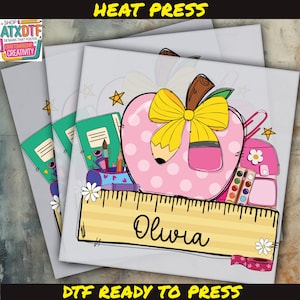 The image is a collage of three images, each featuring a pink apple with a yellow bow and various school supplies, including a ruler and a backpack. The name "Olivia" is written on the ruler, and the text "DFF READY TO PRESS" is displayed at the bottom of the image.