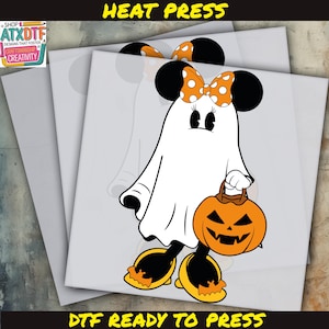 May include: A DTF (Direct to Film) ready-to-press transfer featuring a cartoon ghost with Minnie Mouse ears and a polka dot bow. The ghost is holding a jack-o'-lantern. The words "HEAT PRESS" and "DTF READY TO PRESS" are in the image.