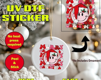 May include: A white ceramic Christmas ornament with a "Merry Christmas" design featuring a smiley face wearing a Santa hat. The image includes text: "UV DTF STICKER", "No heat press required", "Peel & Stick", "Best Quality", and "Fast Production".