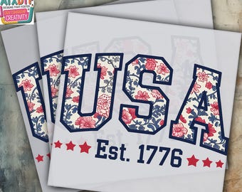 May include: Heat press DTF transfer featuring the word "USA" in a floral pattern with red and blue accents. The design includes the text "Est. 1776" and red stars, perfect for patriotic apparel.